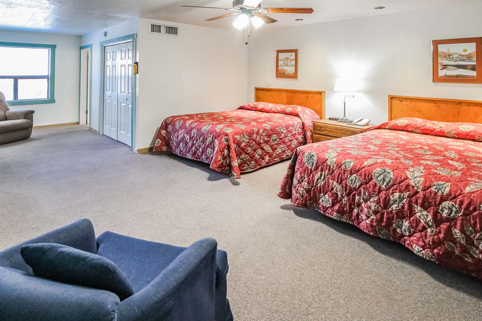 A spacious bedroom with double beds at VRI's Roundhouse Resort in Pinetop, Arizona.